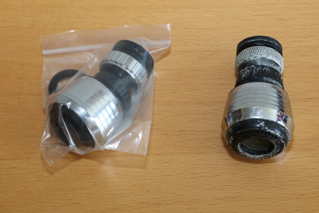 Low water pressure at one faucet: two removable aerator assemblies showing the outlet and visible buildup.