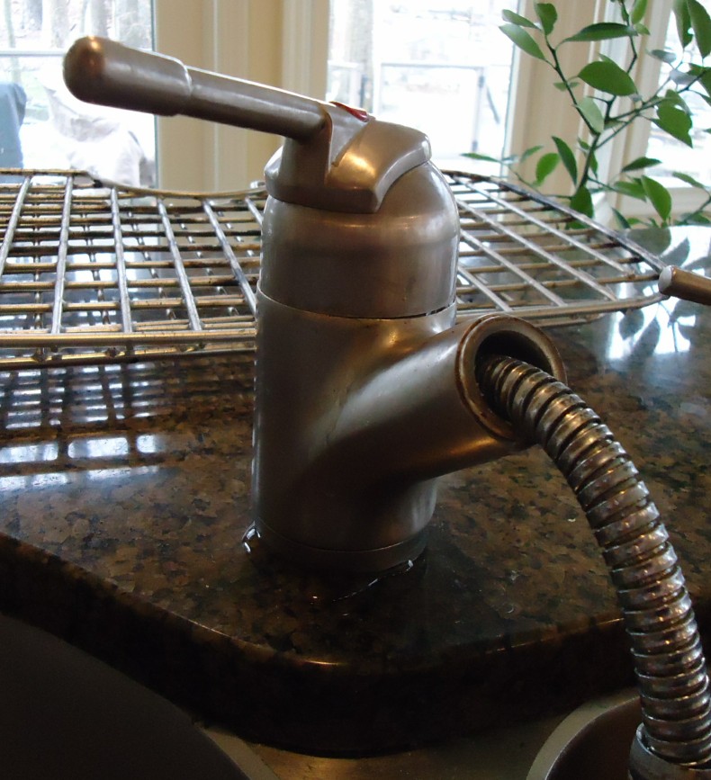 Visible moisture around a Franke kitchen faucet base used to investigate why a faucet drips when turned off.
