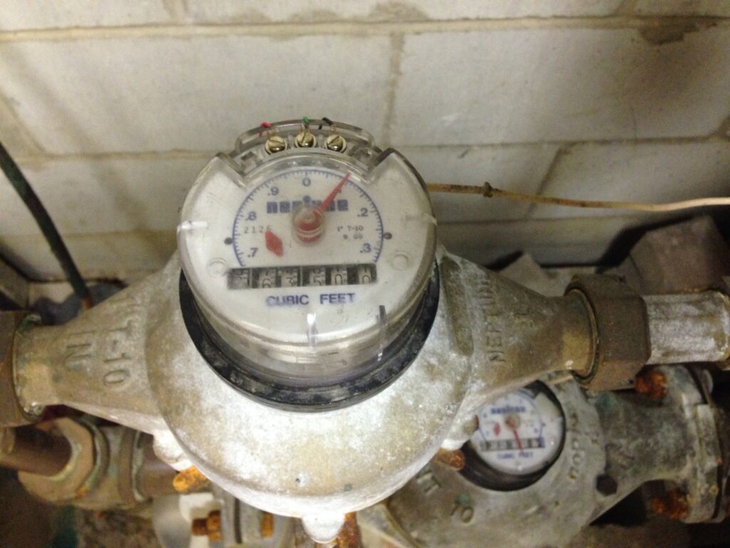 Water meter used to investigate a high water bill but no visible leak, with CUBIC FEET register and flow indicator.